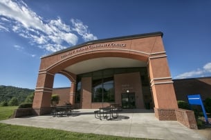 An academic building reads Piedmont Virginia Community College against a blue sky.